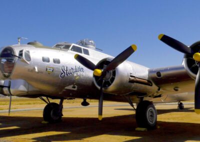 Silver vintage propeller airplane on display.