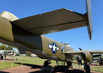 Military aircraft displayed outdoors in museum setting.