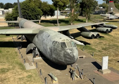Old military aircraft displayed outdoors in museum.